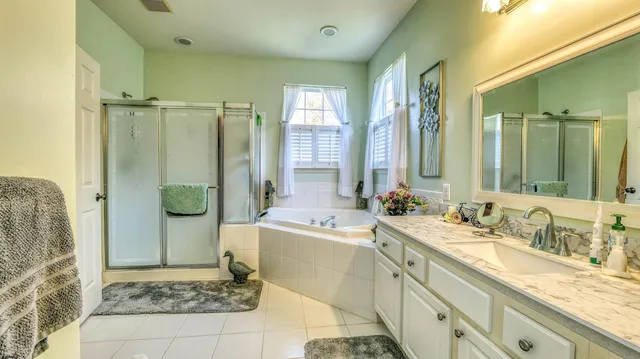 a bathroom with a double vanity sink toilet and shower