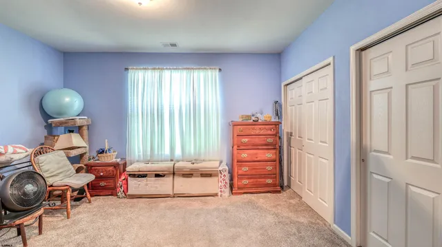 a living room with furniture a window and a chair