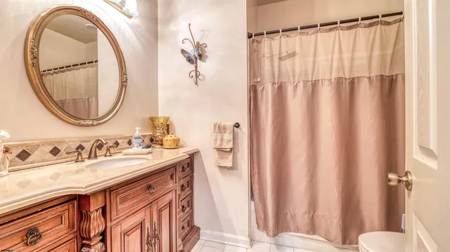 a bathroom with a sink a toilet and a mirror