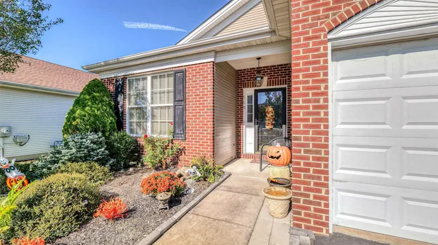 a front view of a house with potted plants