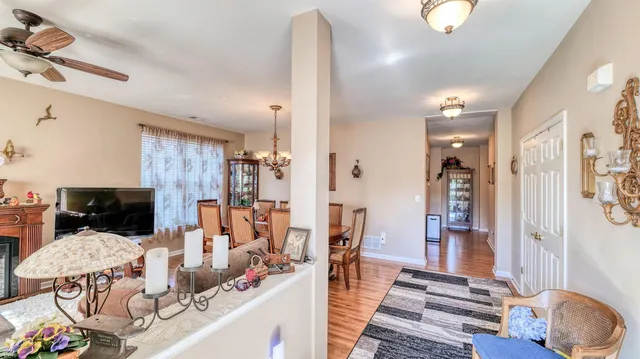 a dining room with furniture and wooden floor