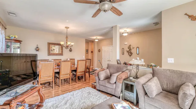a dining room with furniture and a chandelier
