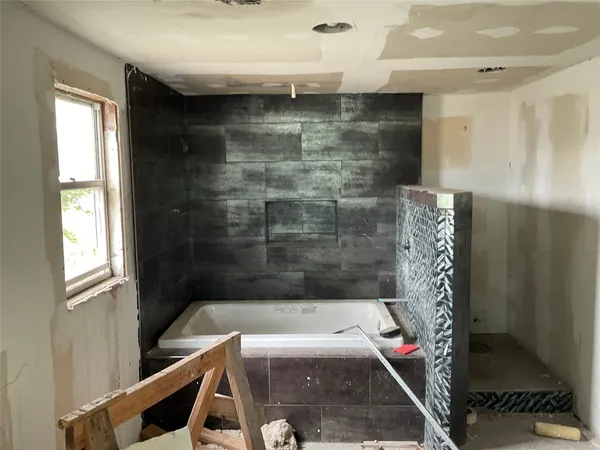 a bathroom with a shower and a sink