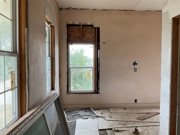 a room with a window and a ceiling fan