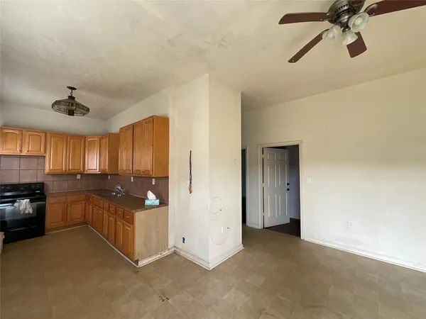 a open kitchen with cabinets and stainless steel appliances
