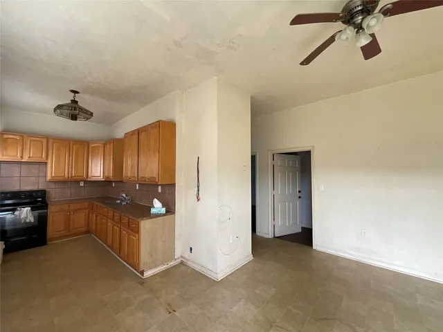 a open kitchen with cabinets and stainless steel appliances