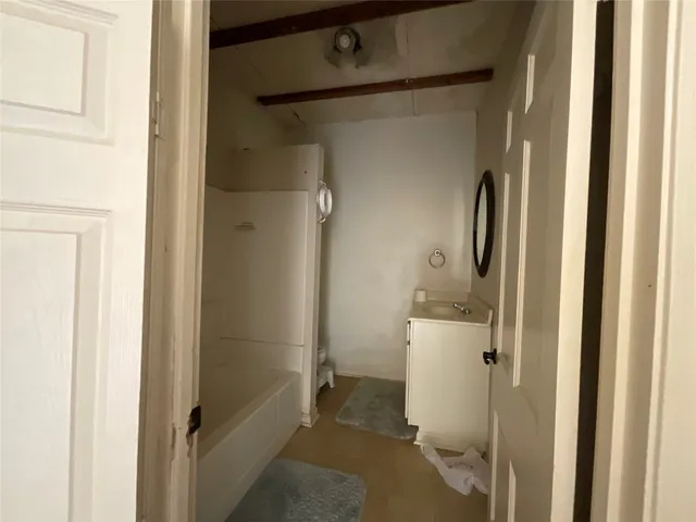 a bathroom with a shower and a sink
