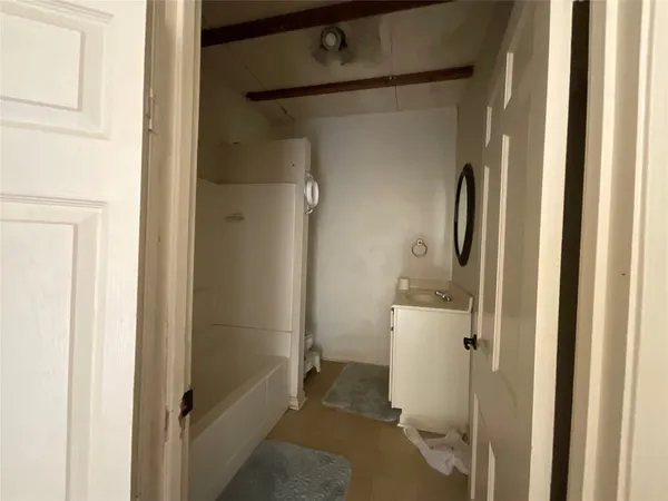a bathroom with a shower and a sink