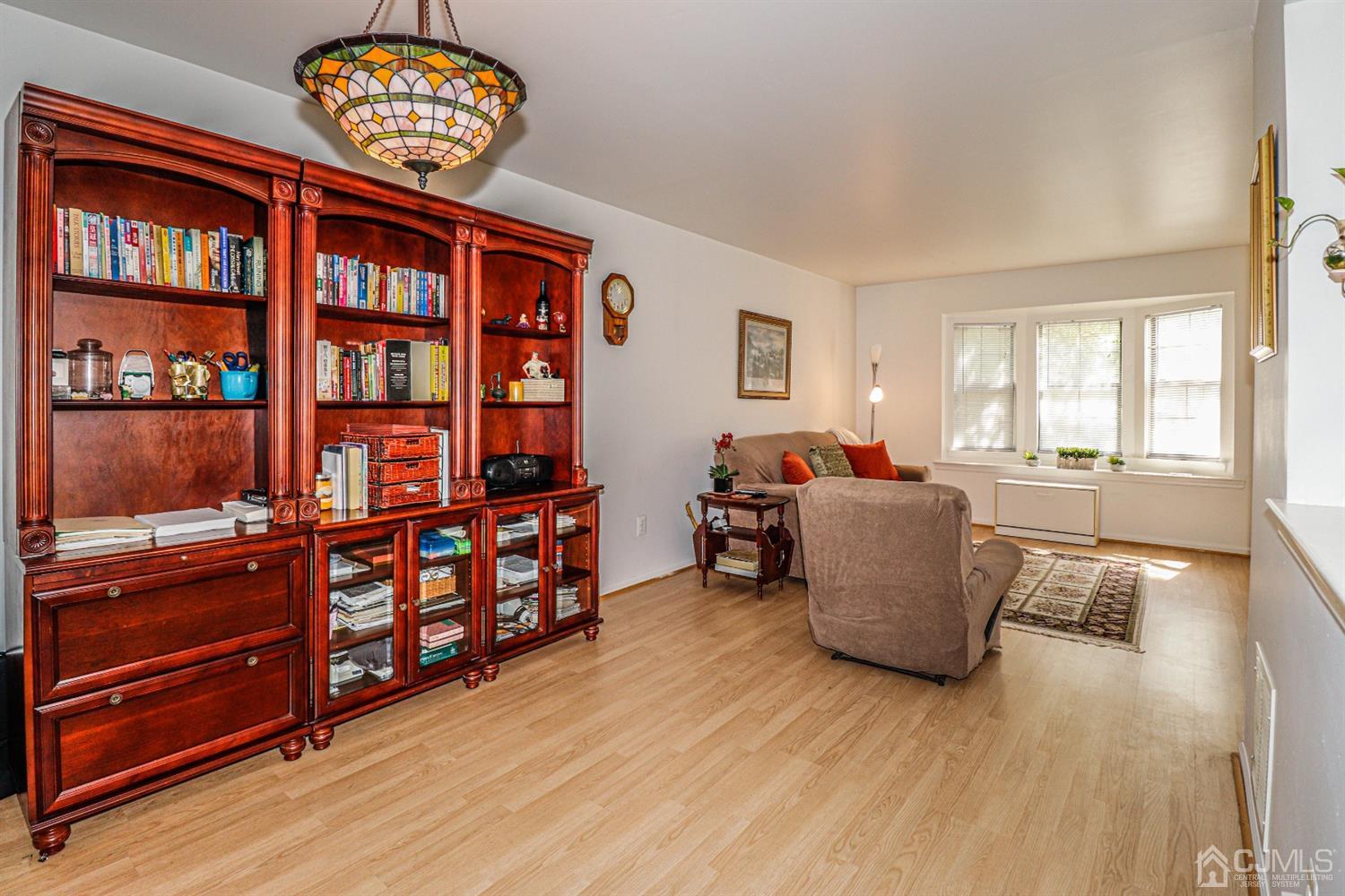 2103 Timber Oaks Road Edison, NJ 08820 - Photo 14 of 33 a living room with furniture cabinets and wooden floor