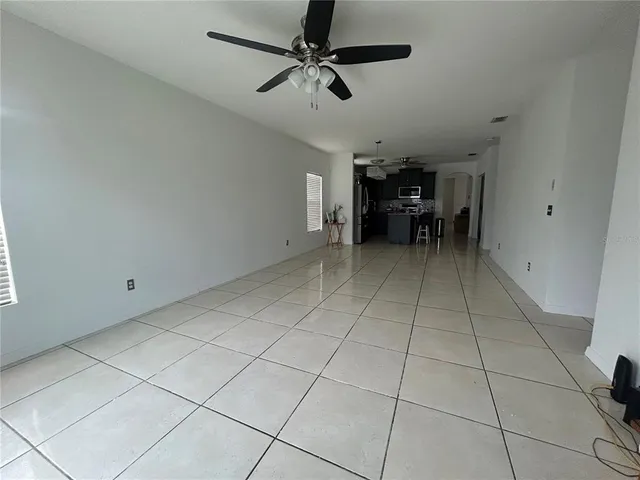 a view of a livingroom with furniture and a ceiling fan