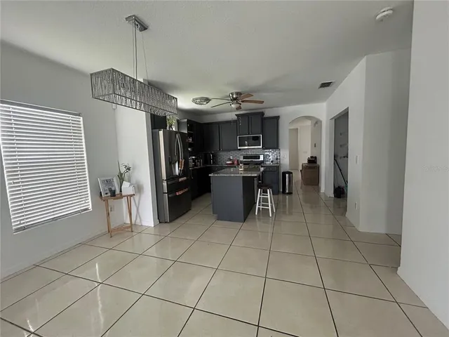a kitchen with stainless steel appliances a refrigerator and a counter top space