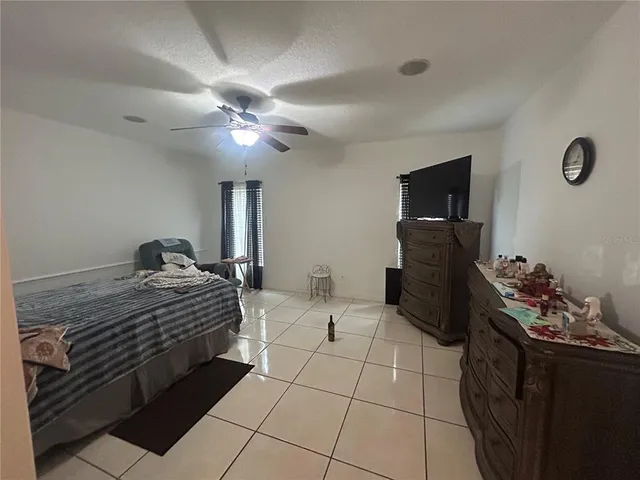a bedroom with bed and a chandelier