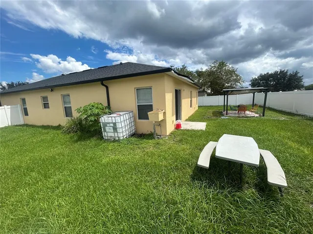 a front view of house with garden and trees