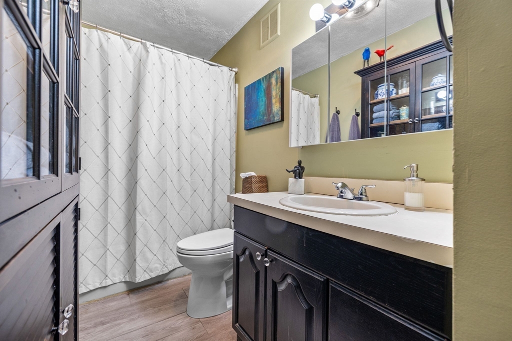 28 Worcester Square, Unit 4 Boston, MA 02118 - Photo 10 of 14 a bathroom with a granite countertop sink a toilet and a mirror