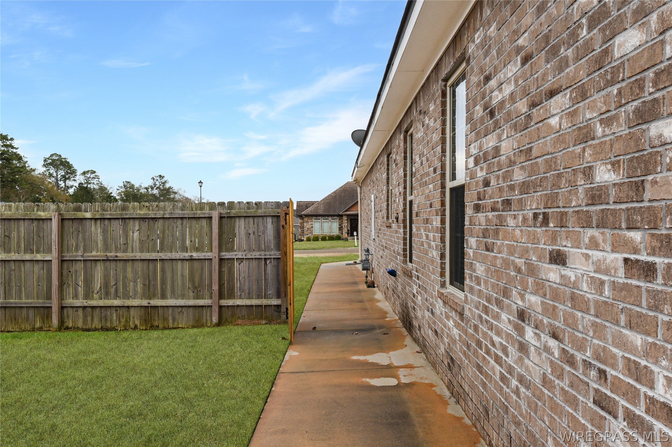 100 Sugarberry Road Dothan, AL 36301 - Photo 25 of 29 sidewalk down east side of house - (no stains, sidewalk is wet)
