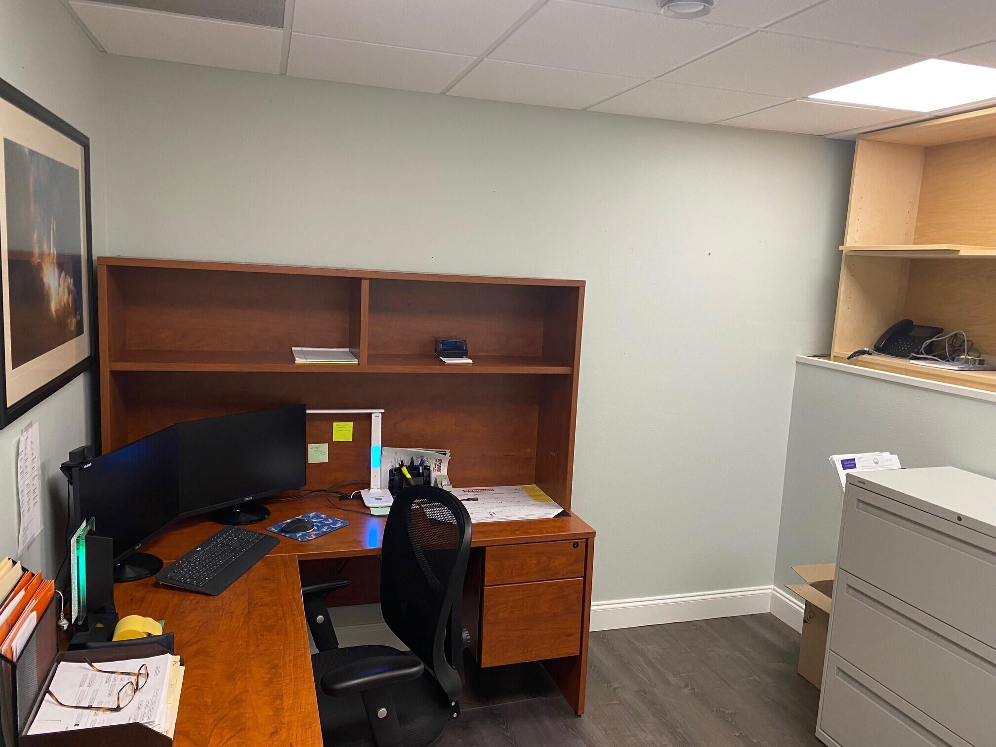 700 South John Rodes Boulevard, Unit B7 & B8 Melbourne, FL 32904 - Photo 3 of 10 a room with furniture and a flat screen tv