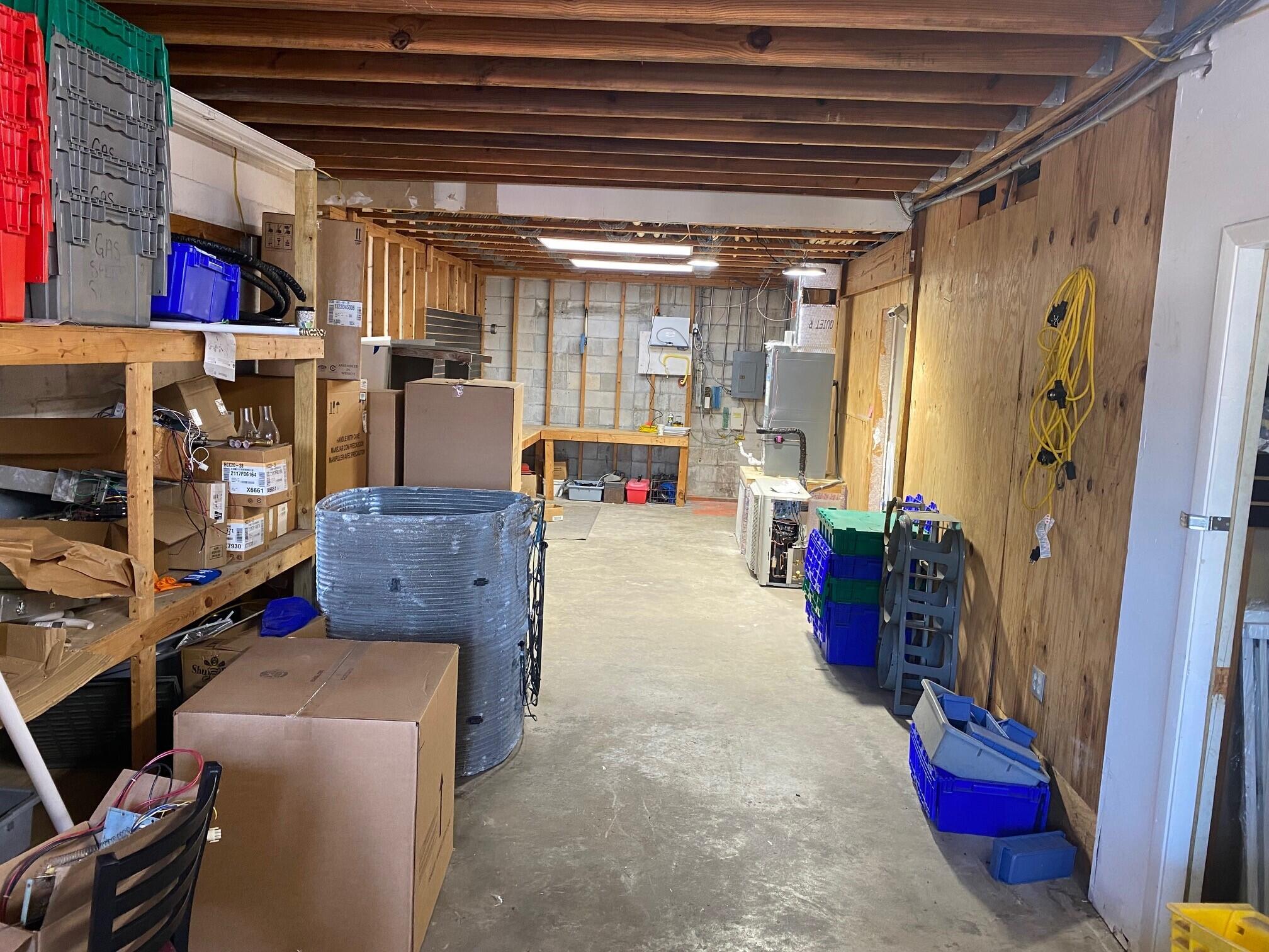 700 South John Rodes Boulevard, Unit B7 & B8 Melbourne, FL 32904 - Photo 7 of 10 a living room with furniture and a book shelf