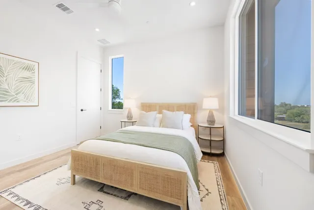 a bedroom with a bed and wooden floor