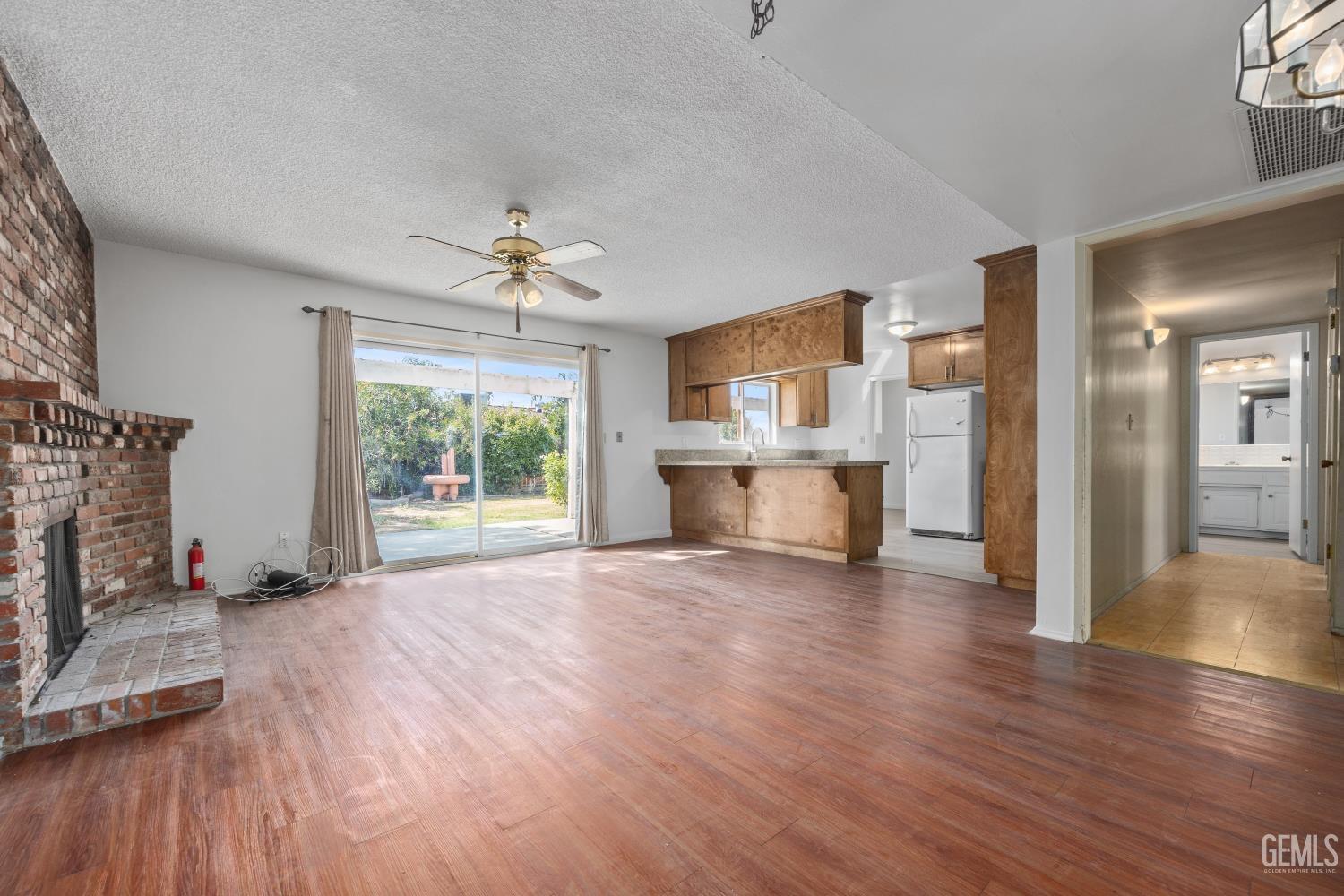 Undisclosed Address Bakersfield, CA 93309 - Photo 11 of 33 a view of a livingroom with wooden floor a fireplace and window