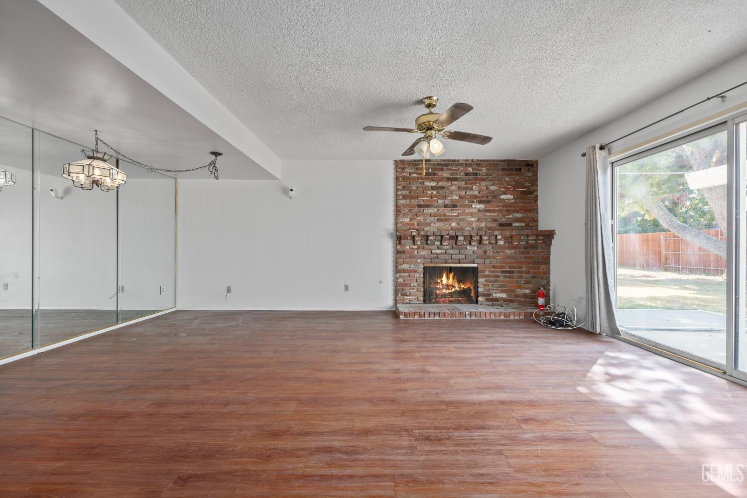 Undisclosed Address Bakersfield, CA 93309 - Photo 12 of 33 a view of an empty room with a fireplace and a window