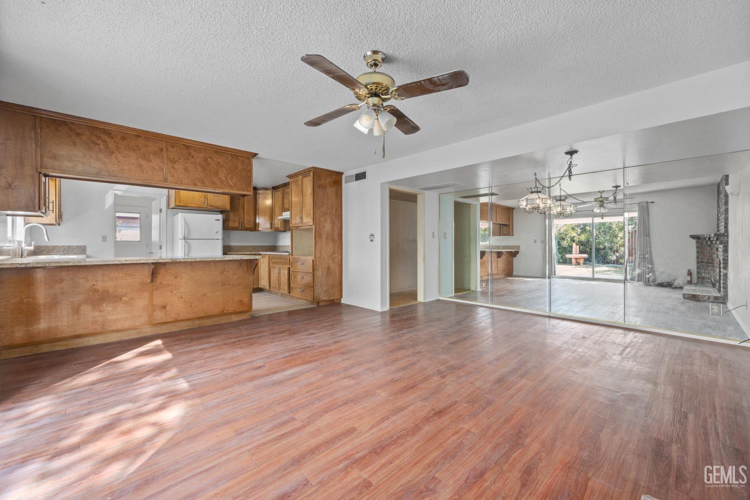 Undisclosed Address Bakersfield, CA 93309 - Photo 13 of 33 a view of a kitchen with a kitchen island wooden floor and stainless steel appliances