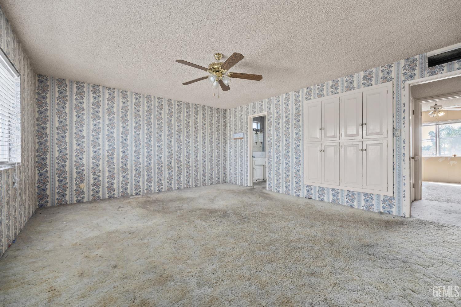 Undisclosed Address Bakersfield, CA 93309 - Photo 18 of 33 an empty room with chandelier fan