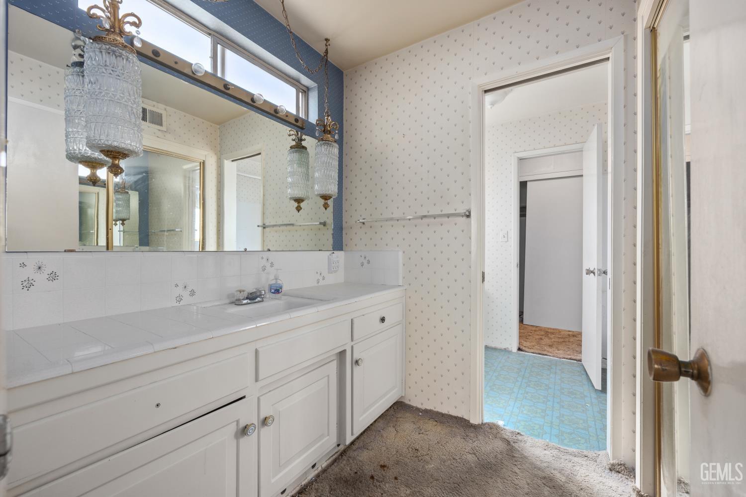 Undisclosed Address Bakersfield, CA 93309 - Photo 20 of 33 a spacious bathroom with a double vanity sink and mirror