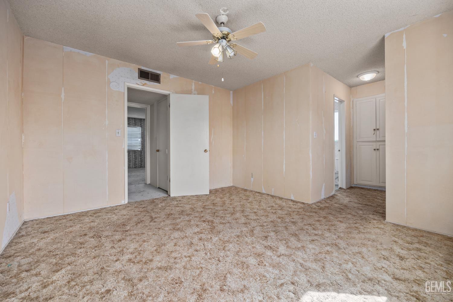Undisclosed Address Bakersfield, CA 93309 - Photo 23 of 33 a view of a big room with a chandelier fan and windows