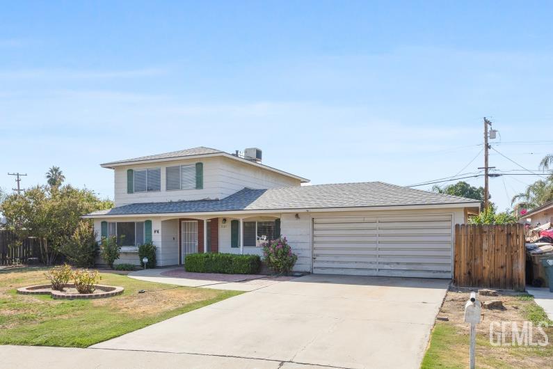 Undisclosed Address Bakersfield, CA 93309 - Photo 3 of 33 a front view of a house with a yard