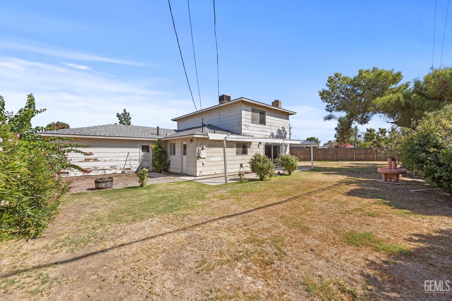 Undisclosed Address Bakersfield, CA 93309 - Photo 31 of 33 a view of a house with a yard and large tree