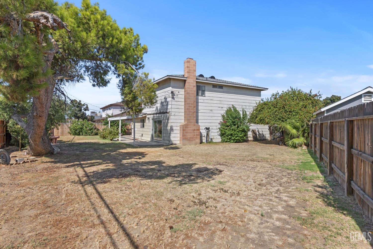 Undisclosed Address Bakersfield, CA 93309 - Photo 32 of 33 a front view of a house with a yard and garage