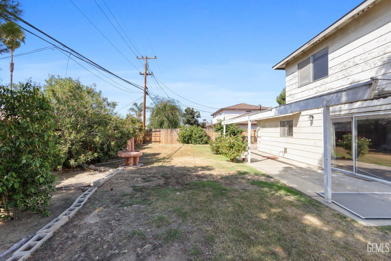 Undisclosed Address Bakersfield, CA 93309 - Photo 33 of 33 a view of a house with backyard and a tree