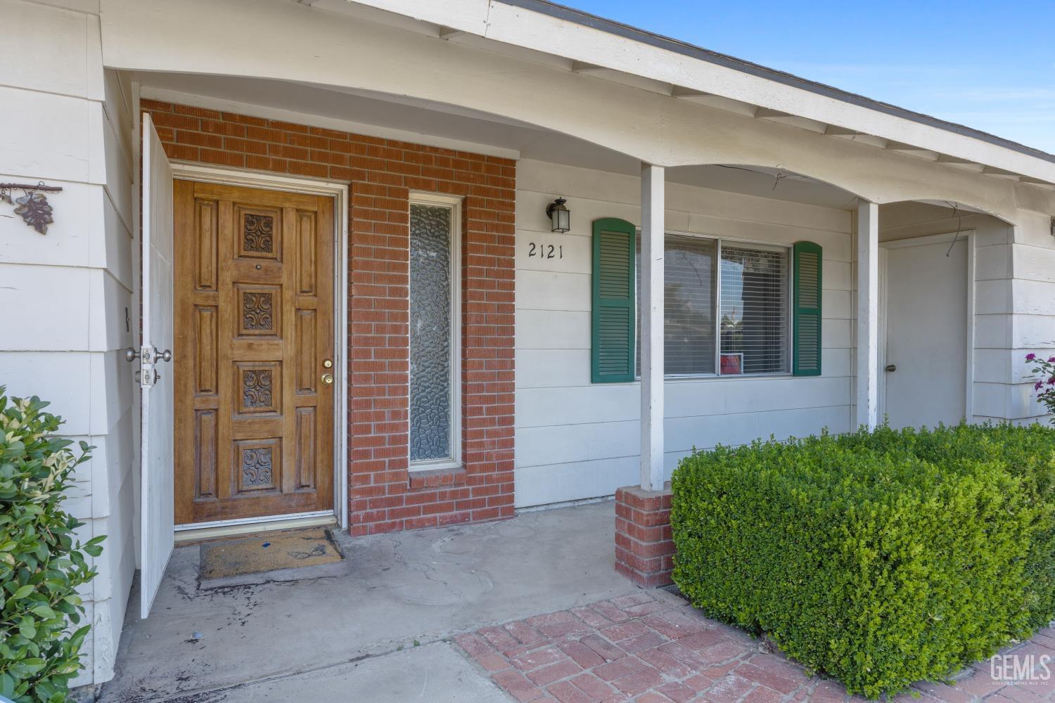 Undisclosed Address Bakersfield, CA 93309 - Photo 4 of 33 front view of a house with a small yard