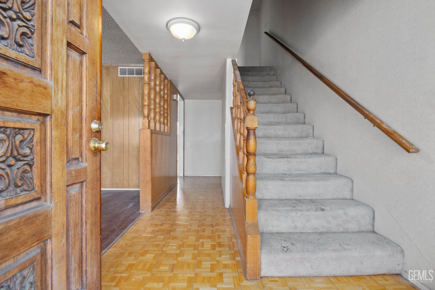 Undisclosed Address Bakersfield, CA 93309 - Photo 5 of 33 a view of a hallway with wooden floor and staircase