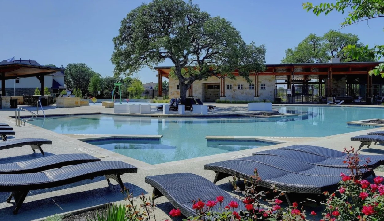 3625 Garrano Bend Leander, TX 78641 - Photo 38 of 38 One of 2 community pools, this expansive outdoor aquatic area featuring a large swimming pool, integrated spas, and surrounding lounge decking