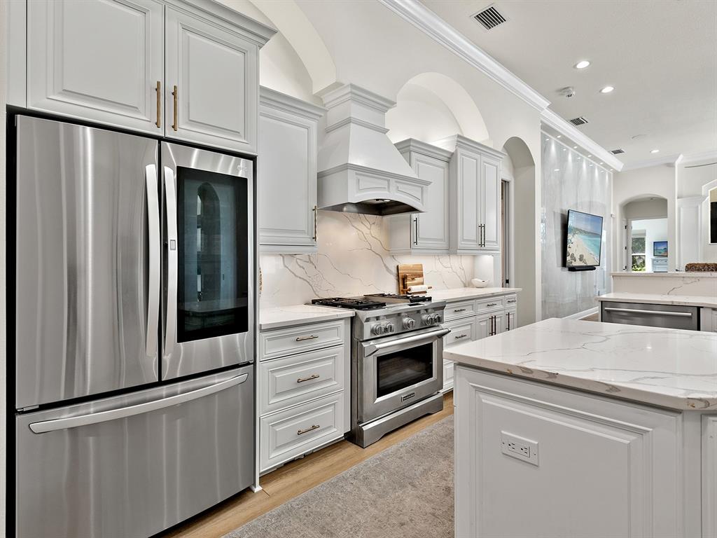 7431 Greystone Street Lakewood Ranch, FL 34202 - Photo 27 of 85 a kitchen with stainless steel appliances granite countertop a stove a refrigerator and a microwave