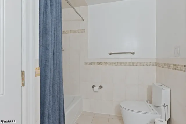 a bathroom with a granite countertop toilet and a sink