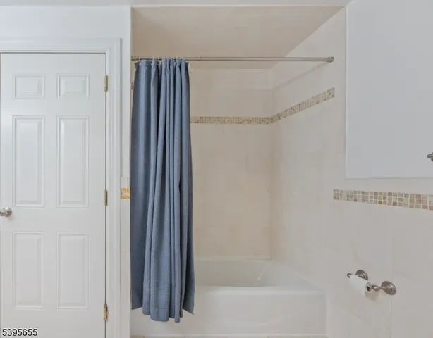 a bathroom with a shower and a glass door