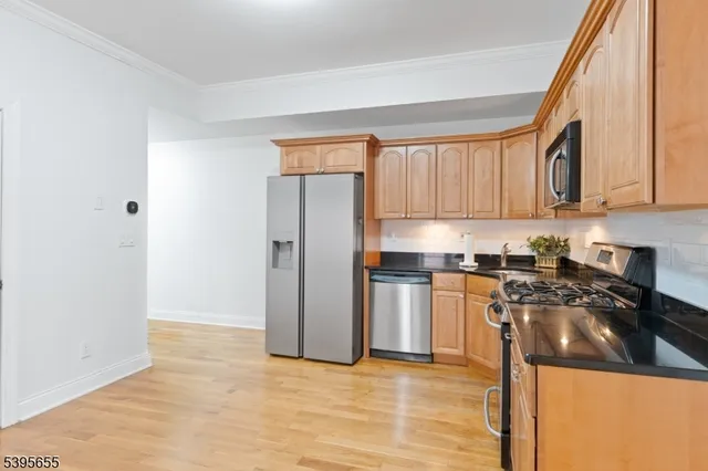 a kitchen with a refrigerator and a sink