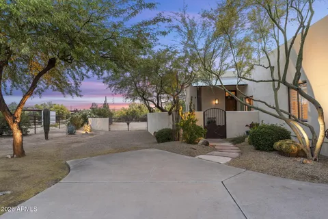 a front view of a house with a yard and tree s