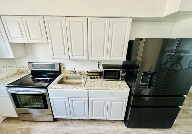 a kitchen with a sink and a refrigerator