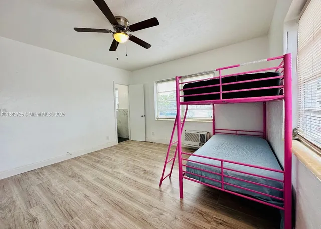 a bed room with a bed and a ceiling fan