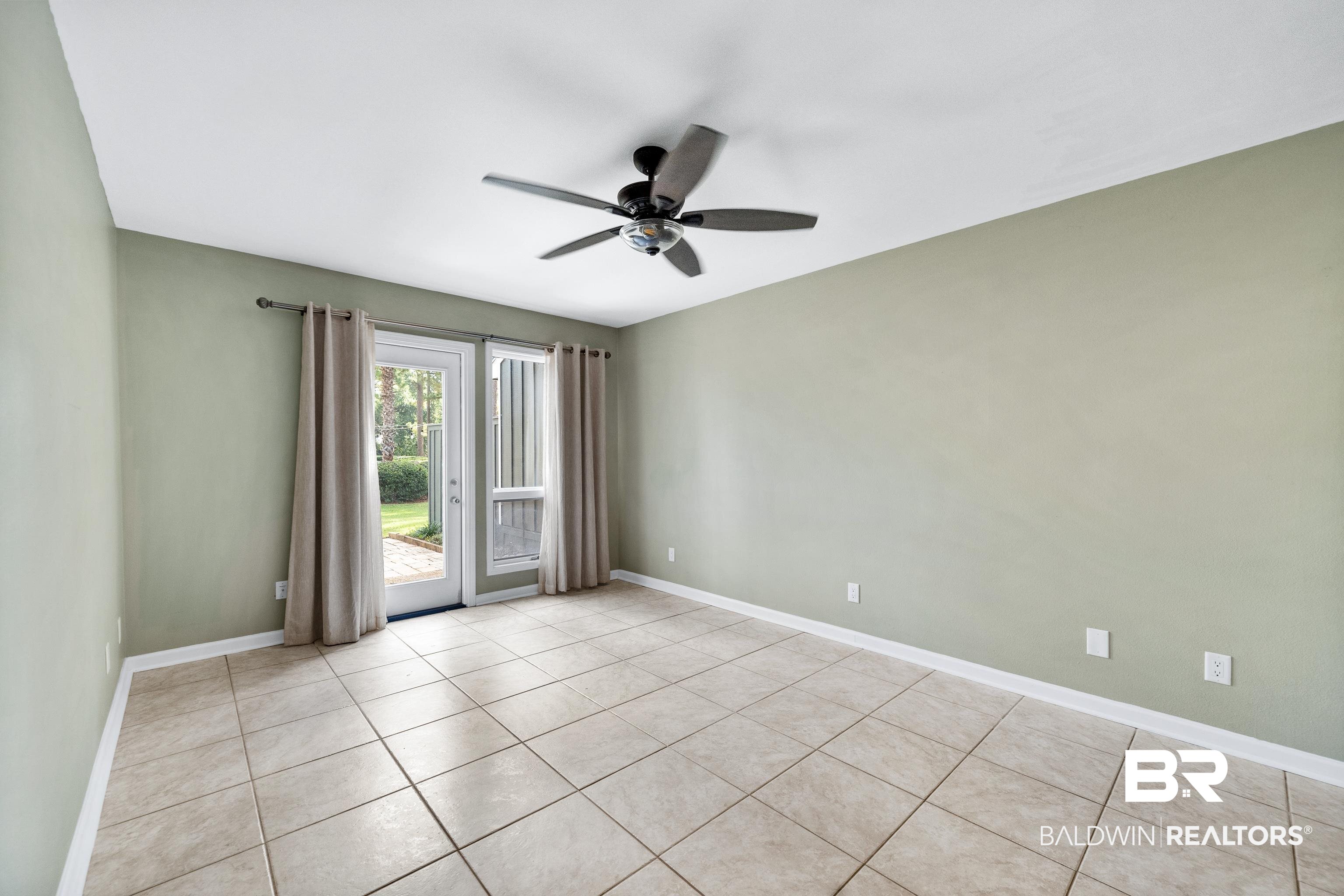 1701 Regency Road, Unit 111 Gulf Shores, AL 36542 - Photo 14 of 29 Spare room with light tile patterned flooring and ceiling fan