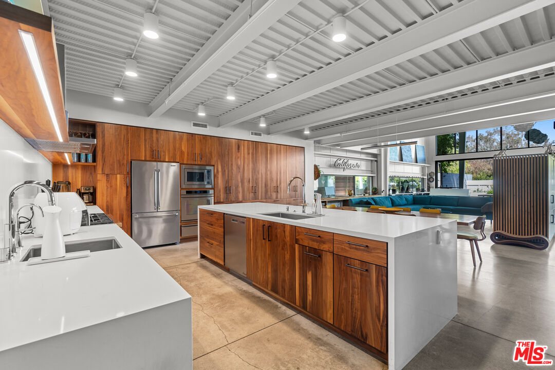 548 Rose Avenue Venice, CA 90291 - Photo 22 of 48 a kitchen with stainless steel appliances granite countertop a sink a stove and a refrigerator