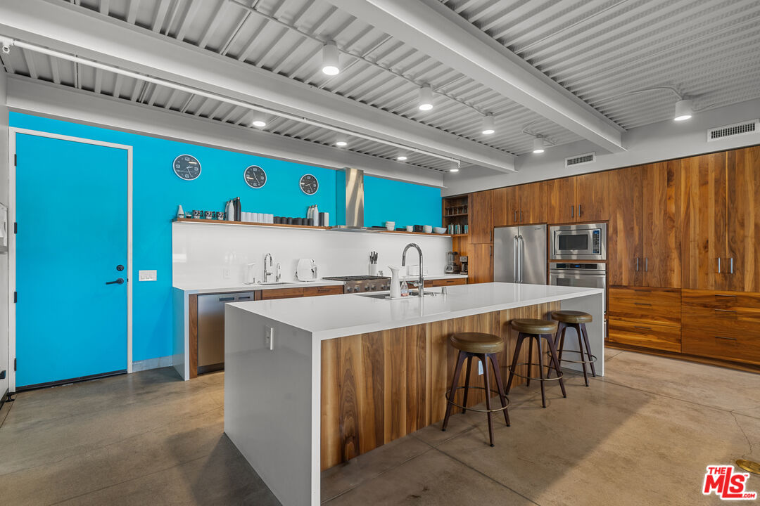 548 Rose Avenue Venice, CA 90291 - Photo 24 of 48 a kitchen with a wooden table and chairs