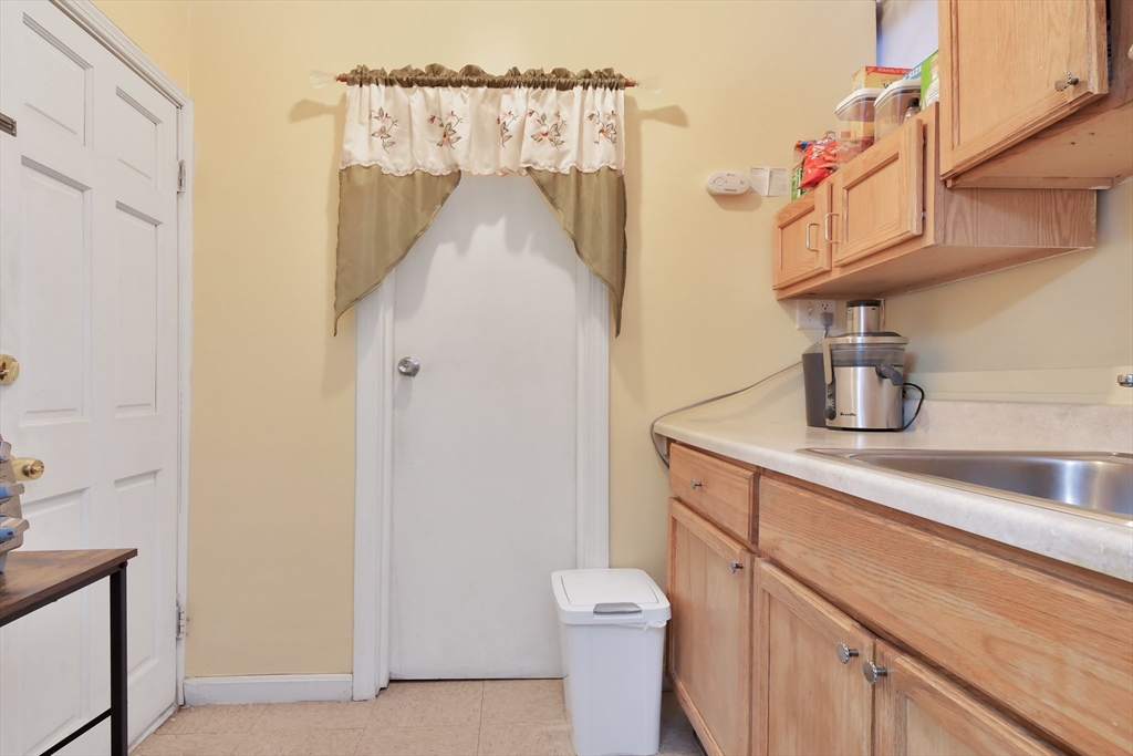 276 Broadway Lawrence, MA 01841 - Photo 11 of 27 a bathroom with a sink a toilet and shower