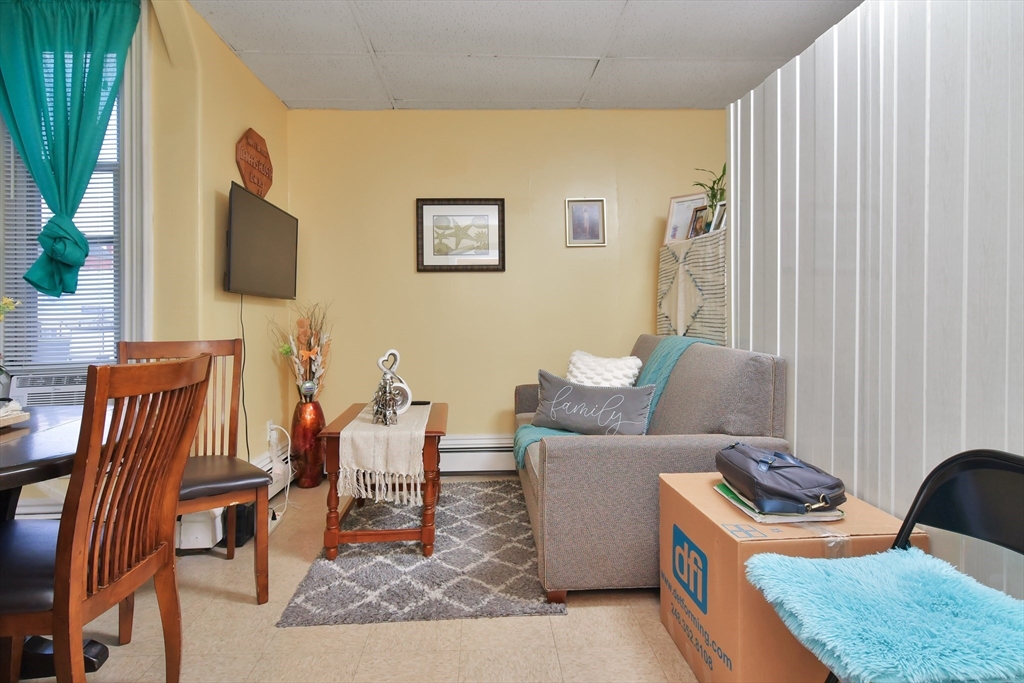 276 Broadway Lawrence, MA 01841 - Photo 12 of 27 a living room with furniture and a flat screen tv
