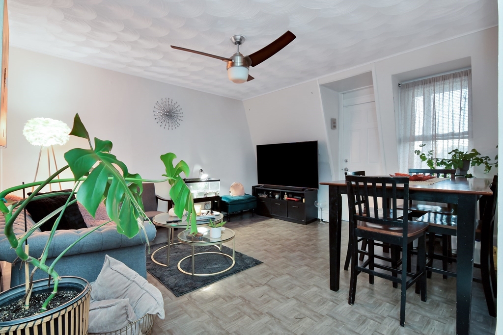 276 Broadway Lawrence, MA 01841 - Photo 14 of 27 a living room with furniture a window and a flat screen tv