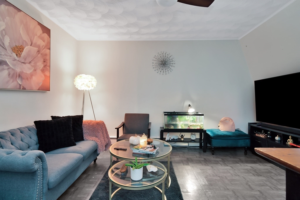 276 Broadway Lawrence, MA 01841 - Photo 15 of 27 a living room with furniture and a flat screen tv