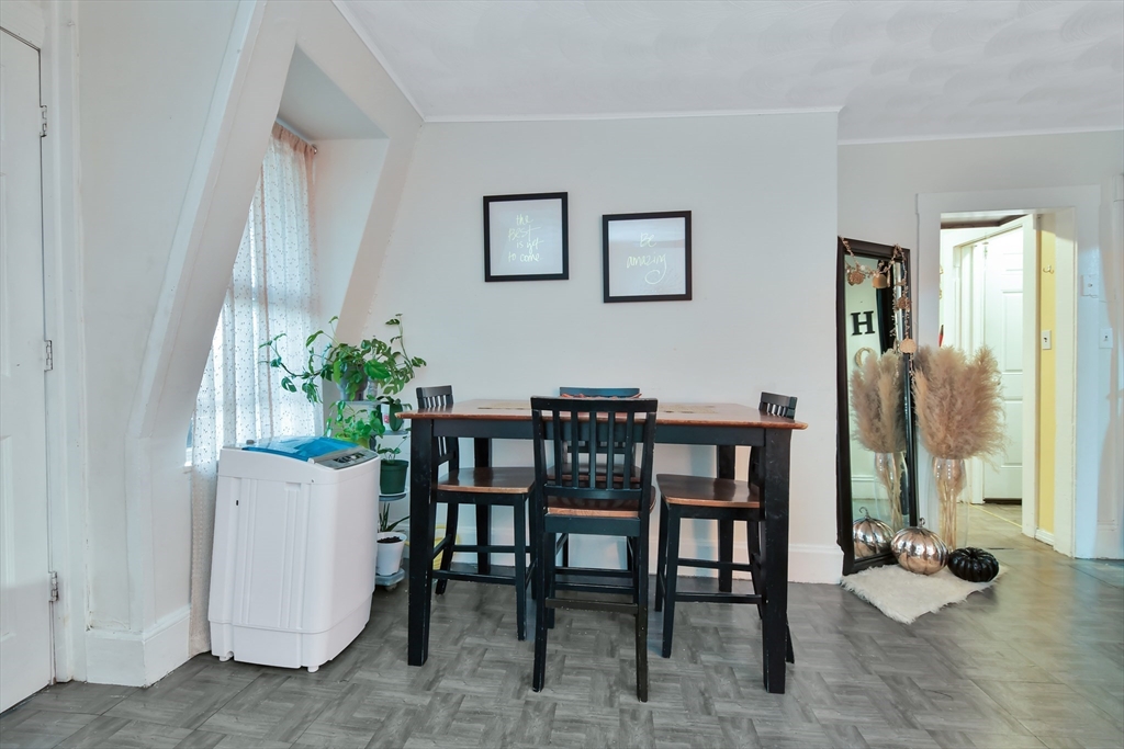 276 Broadway Lawrence, MA 01841 - Photo 16 of 27 a dining room with furniture and potted plants